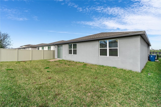 rear view of property featuring a yard