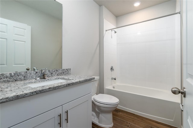 full bathroom with shower / bathing tub combination, vanity, wood-type flooring, and toilet