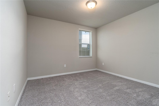 empty room featuring carpet flooring and a textured ceiling