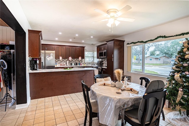 tiled dining room with ceiling fan