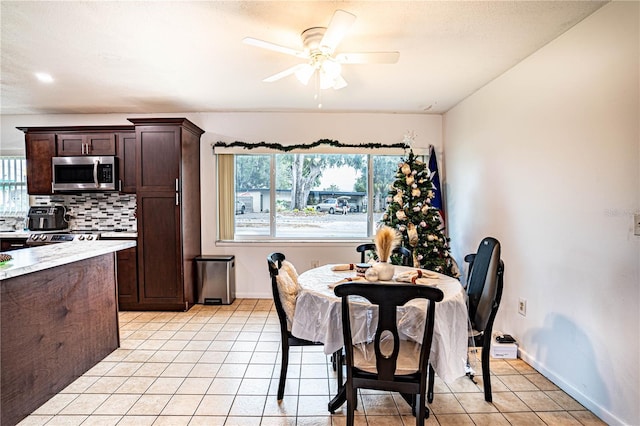 dining room with light tile patterned floors and ceiling fan