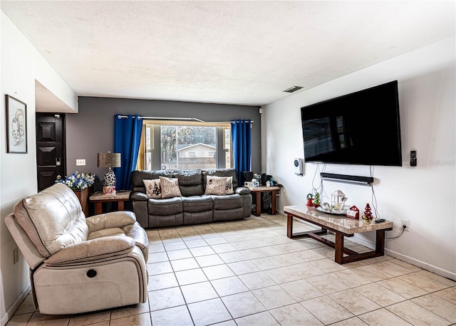 living room featuring light tile patterned floors and a textured ceiling