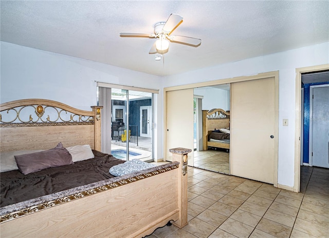 bedroom featuring ceiling fan, access to exterior, a textured ceiling, and a closet