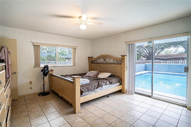 tiled bedroom featuring access to outside, multiple windows, and ceiling fan