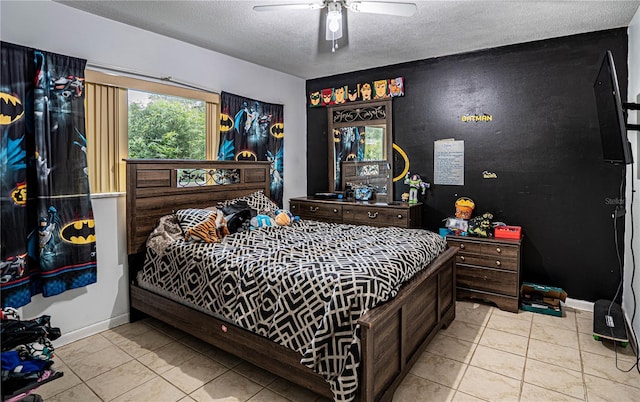 bedroom with ceiling fan, light tile patterned floors, and a textured ceiling