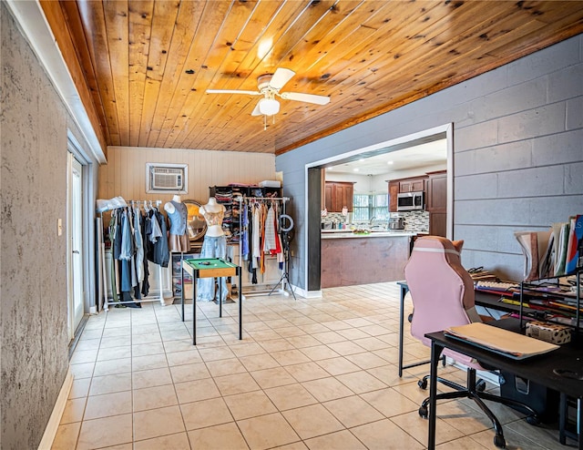 interior space with ceiling fan, plenty of natural light, and wood ceiling