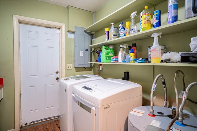 laundry area with dark hardwood / wood-style flooring, electric panel, water heater, and washing machine and clothes dryer