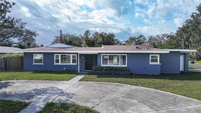 ranch-style home with a front lawn