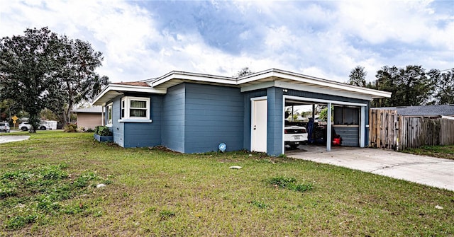 view of front of home with a carport and a front lawn