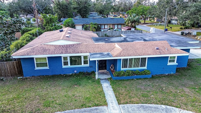 ranch-style home with a front lawn