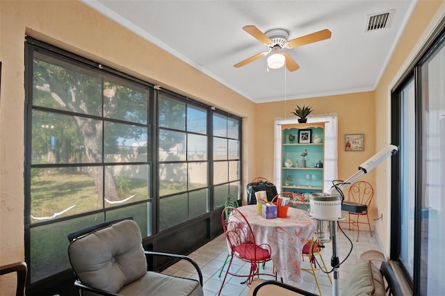 sunroom / solarium with outdoor dining space, ceiling fan, and visible vents