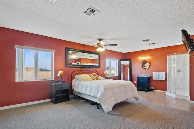 carpeted bedroom with baseboards, a textured ceiling, visible vents, and tile patterned floors