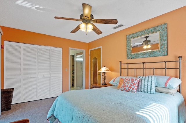carpeted bedroom featuring visible vents, a closet, and ceiling fan