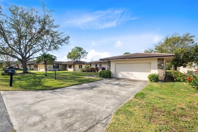 ranch-style home featuring a front yard, stone siding, concrete driveway, stucco siding, and a garage