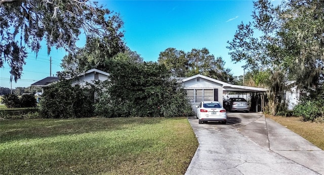 view of front of property featuring a carport and a front lawn