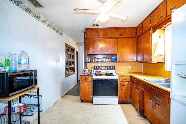 kitchen featuring electric stove, ceiling fan, and sink