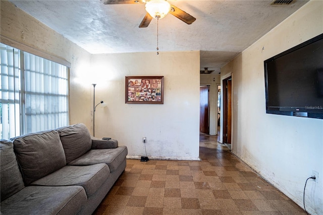 living room with ceiling fan and a healthy amount of sunlight