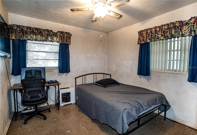 bedroom featuring parquet floors and ceiling fan