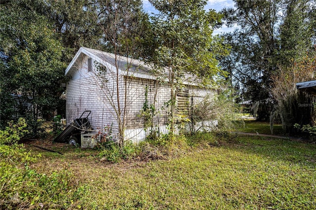 view of property exterior featuring a lawn