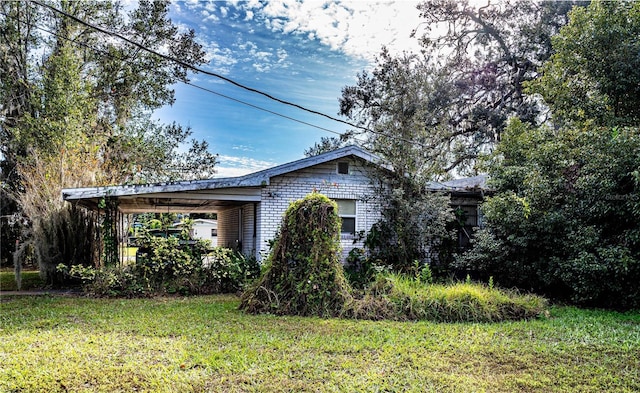 obstructed view of property with a front yard and a carport