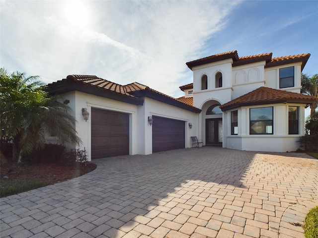 mediterranean / spanish-style house with a garage