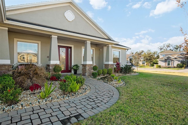 exterior space with covered porch and a lawn