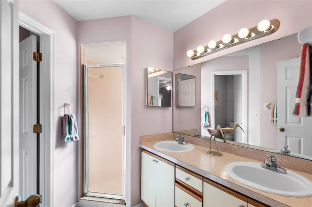 bathroom with vanity and a shower with door