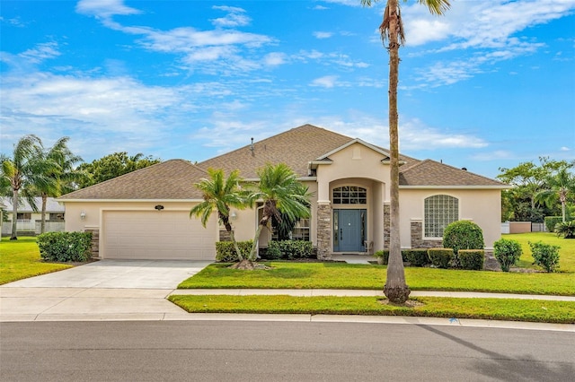 view of front of property with a front yard and a garage