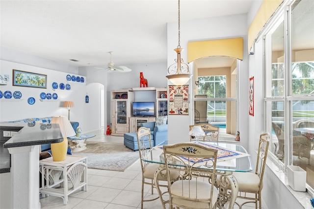 dining space featuring ceiling fan and light tile patterned floors