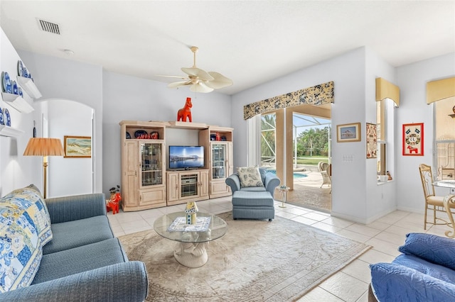 living room featuring light tile patterned floors and ceiling fan