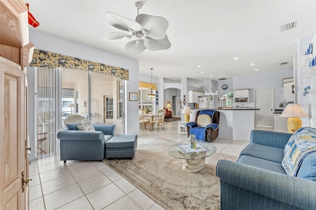 living room featuring light tile patterned floors and ceiling fan