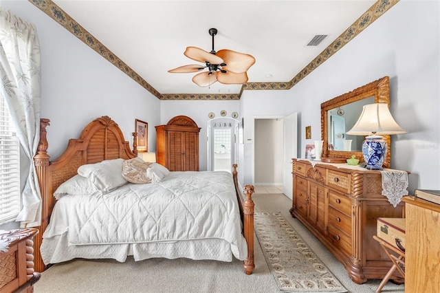 bedroom featuring light colored carpet and ceiling fan