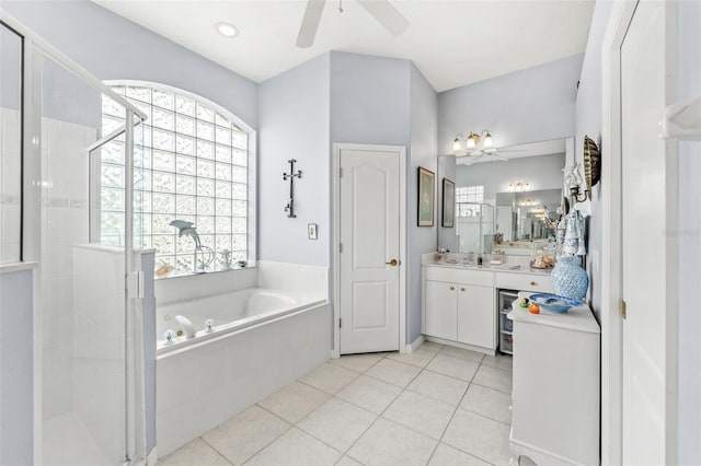 bathroom featuring plus walk in shower, vanity, ceiling fan, and tile patterned flooring