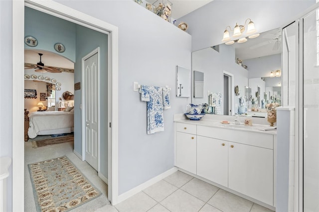 bathroom featuring tile patterned floors, vanity, ceiling fan, and a shower with door