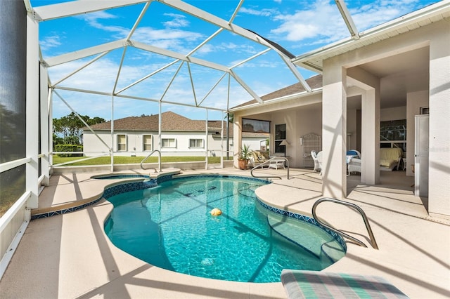 view of pool with a lanai, a patio area, and an in ground hot tub