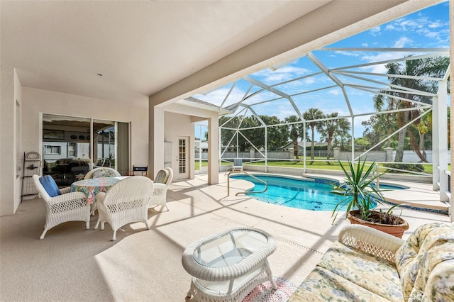 view of swimming pool with a patio area and a lanai