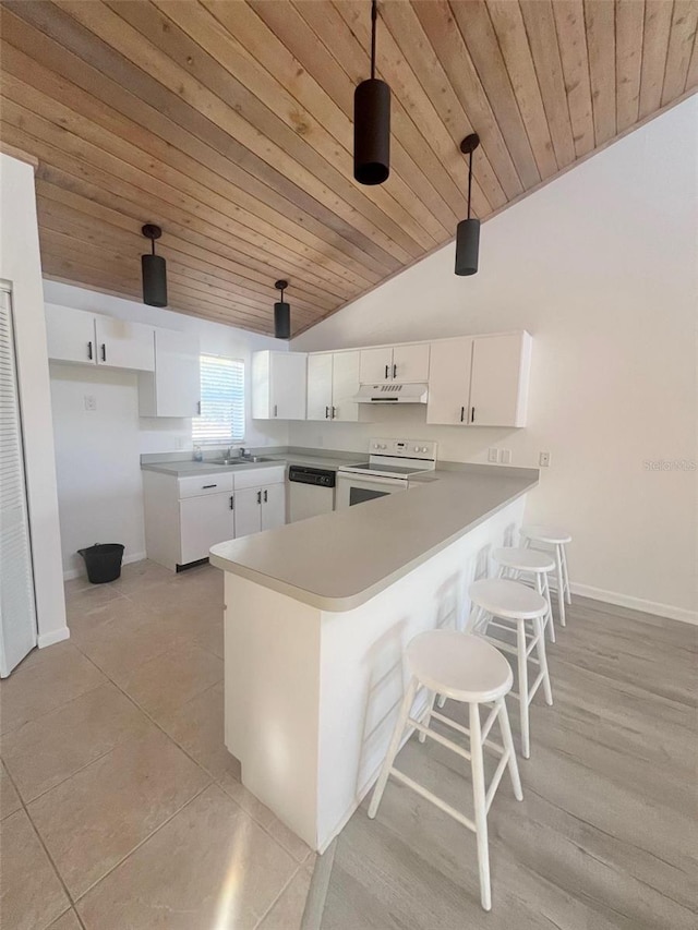 kitchen with kitchen peninsula, pendant lighting, vaulted ceiling, white appliances, and white cabinets