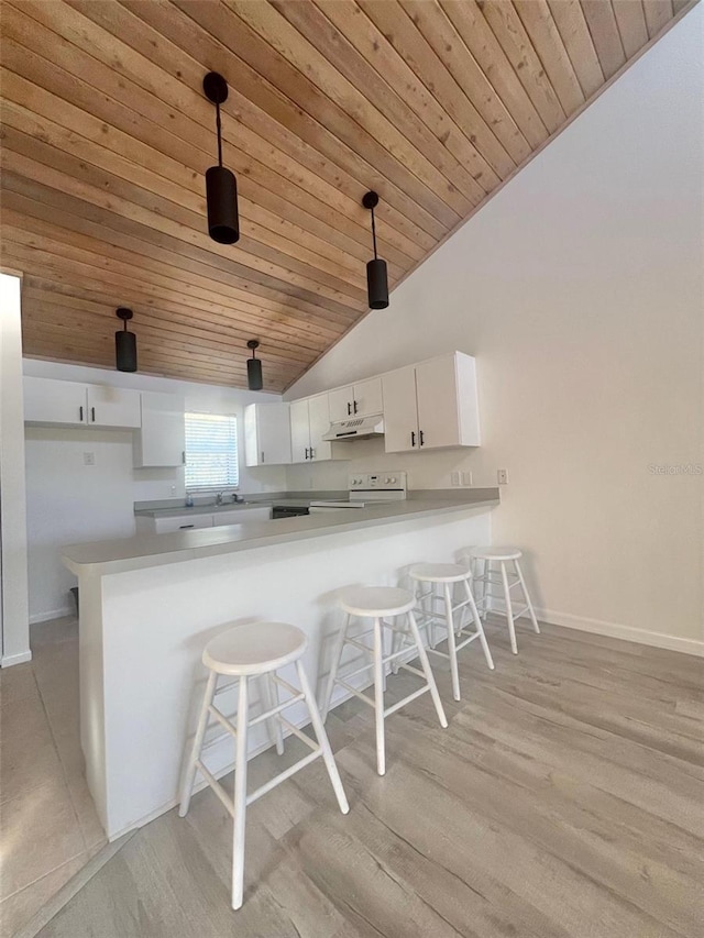 kitchen featuring white cabinetry, white electric range oven, kitchen peninsula, decorative light fixtures, and a kitchen bar