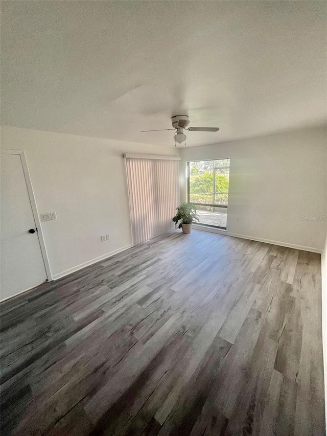 spare room featuring wood-type flooring and ceiling fan