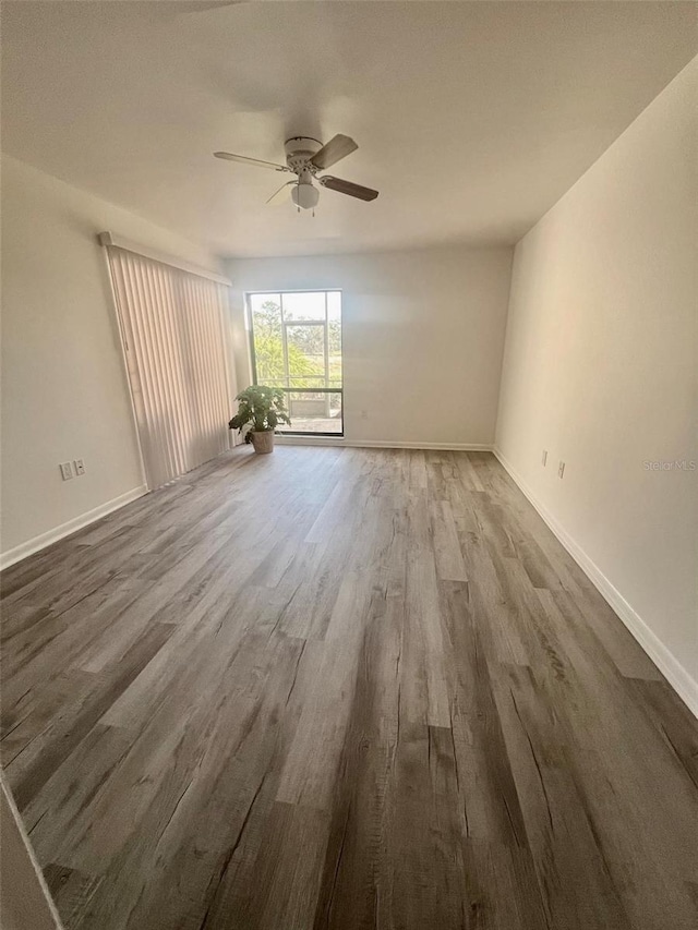 empty room featuring ceiling fan and hardwood / wood-style floors