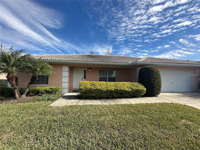 single story home with a front yard and a garage