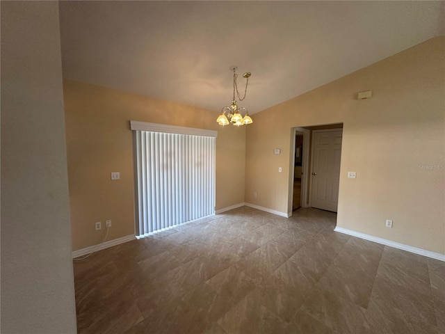 spare room with a chandelier and vaulted ceiling