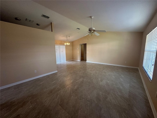 unfurnished living room with ceiling fan with notable chandelier and lofted ceiling