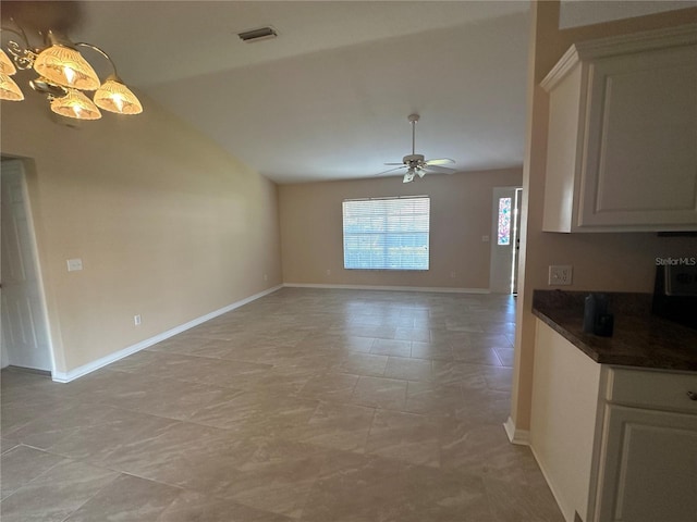 unfurnished dining area featuring vaulted ceiling and ceiling fan