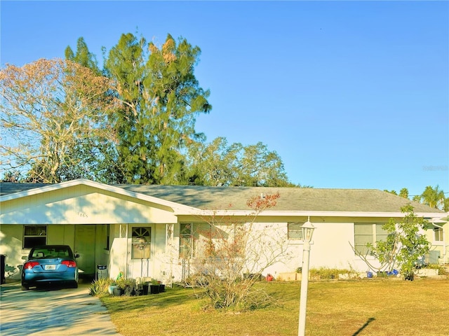 single story home featuring a carport and a front yard