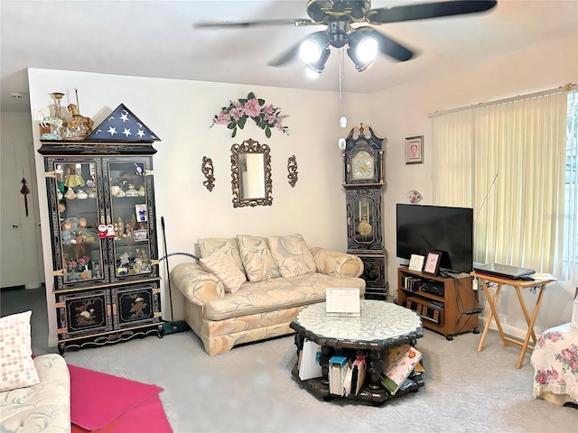 carpeted living room with ceiling fan