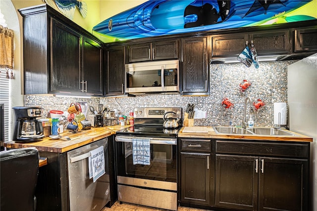 kitchen with backsplash, sink, dark brown cabinetry, butcher block counters, and stainless steel appliances