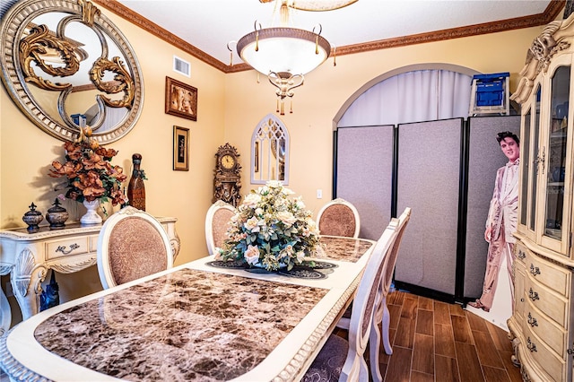 dining area with crown molding