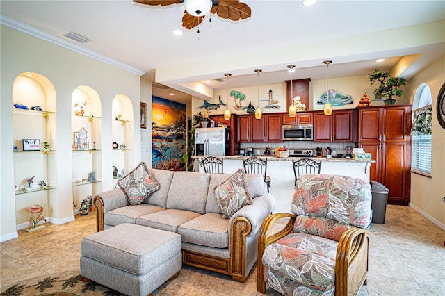 living room with built in shelves, light tile patterned floors, ceiling fan, and crown molding