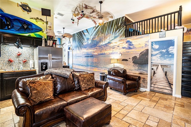 living room featuring ceiling fan and sink